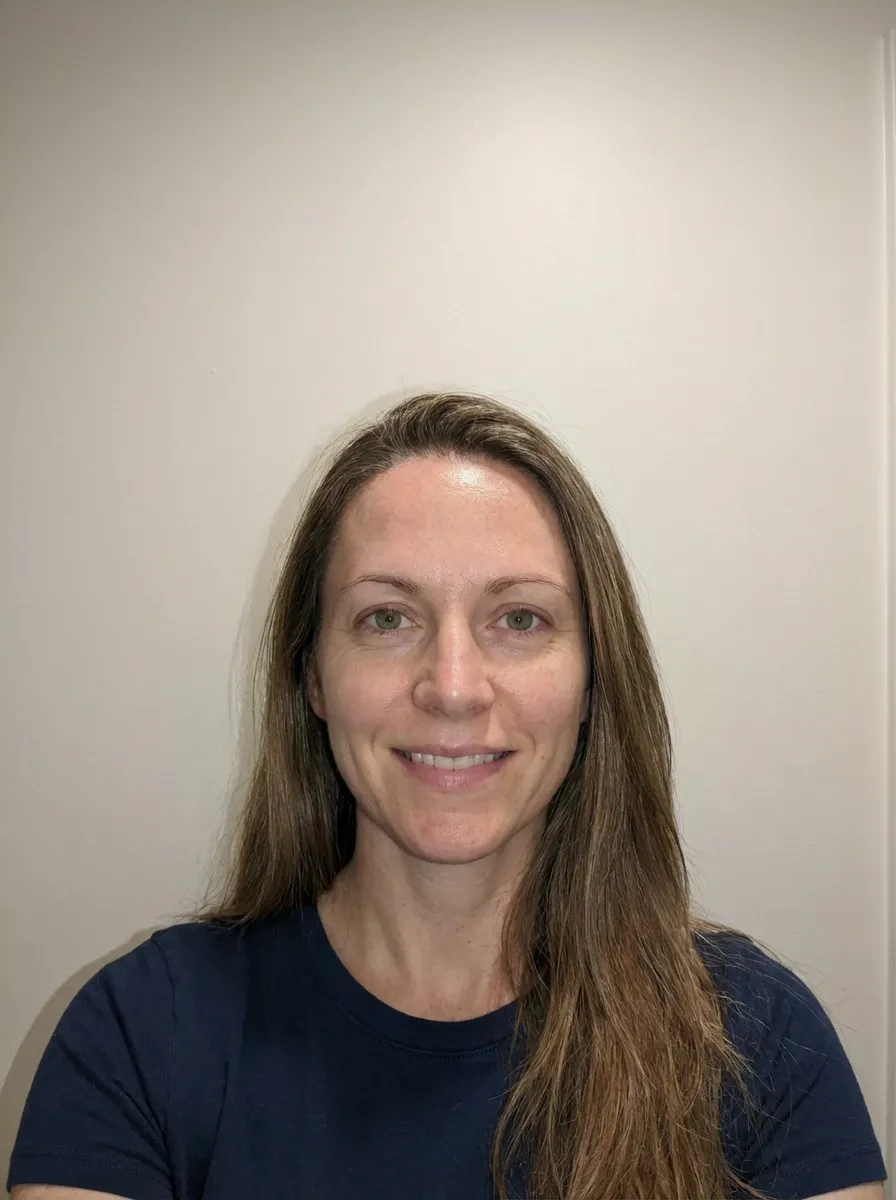 Original selfie input — woman in a navy top indoors